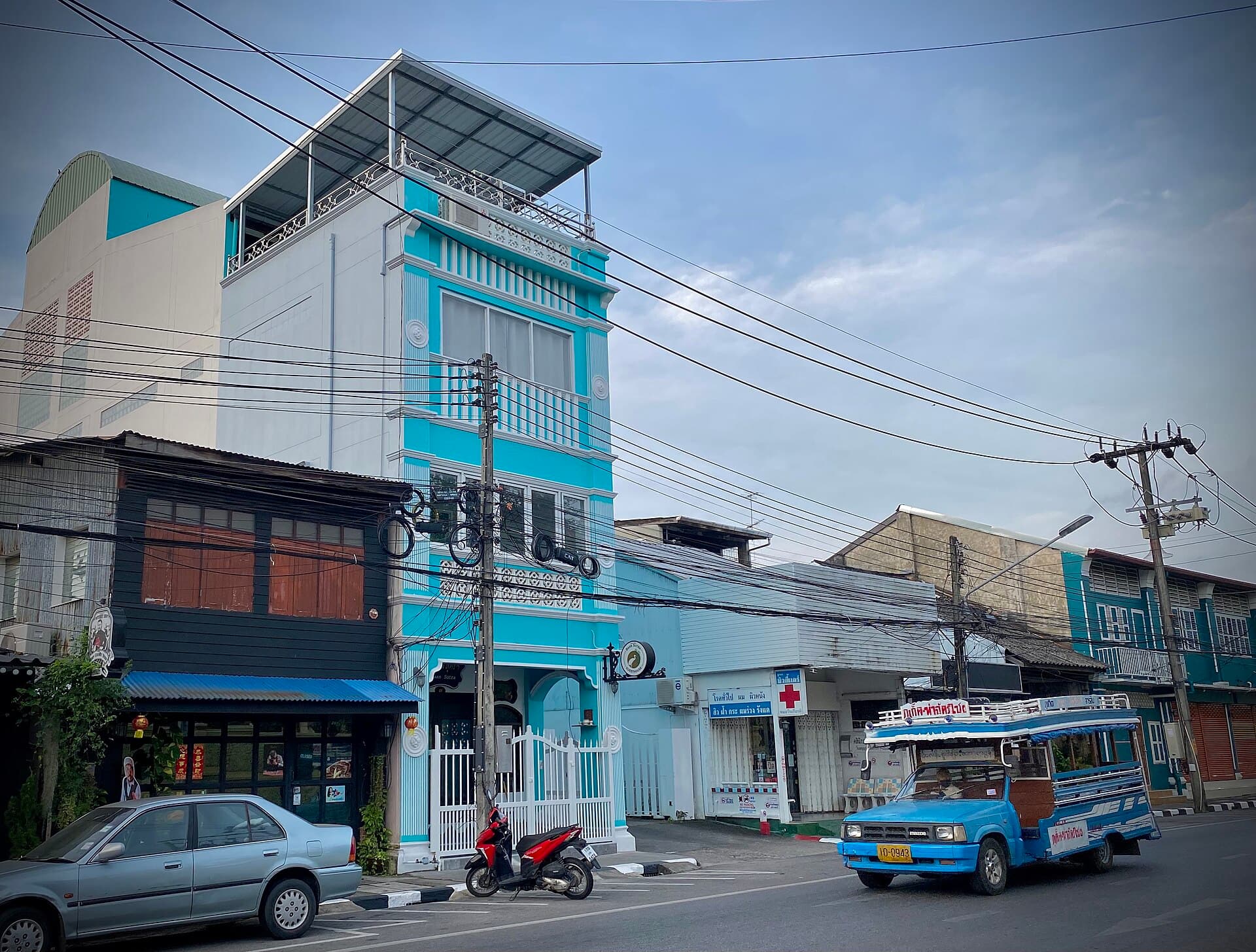 A blue local bus on a Phuket street